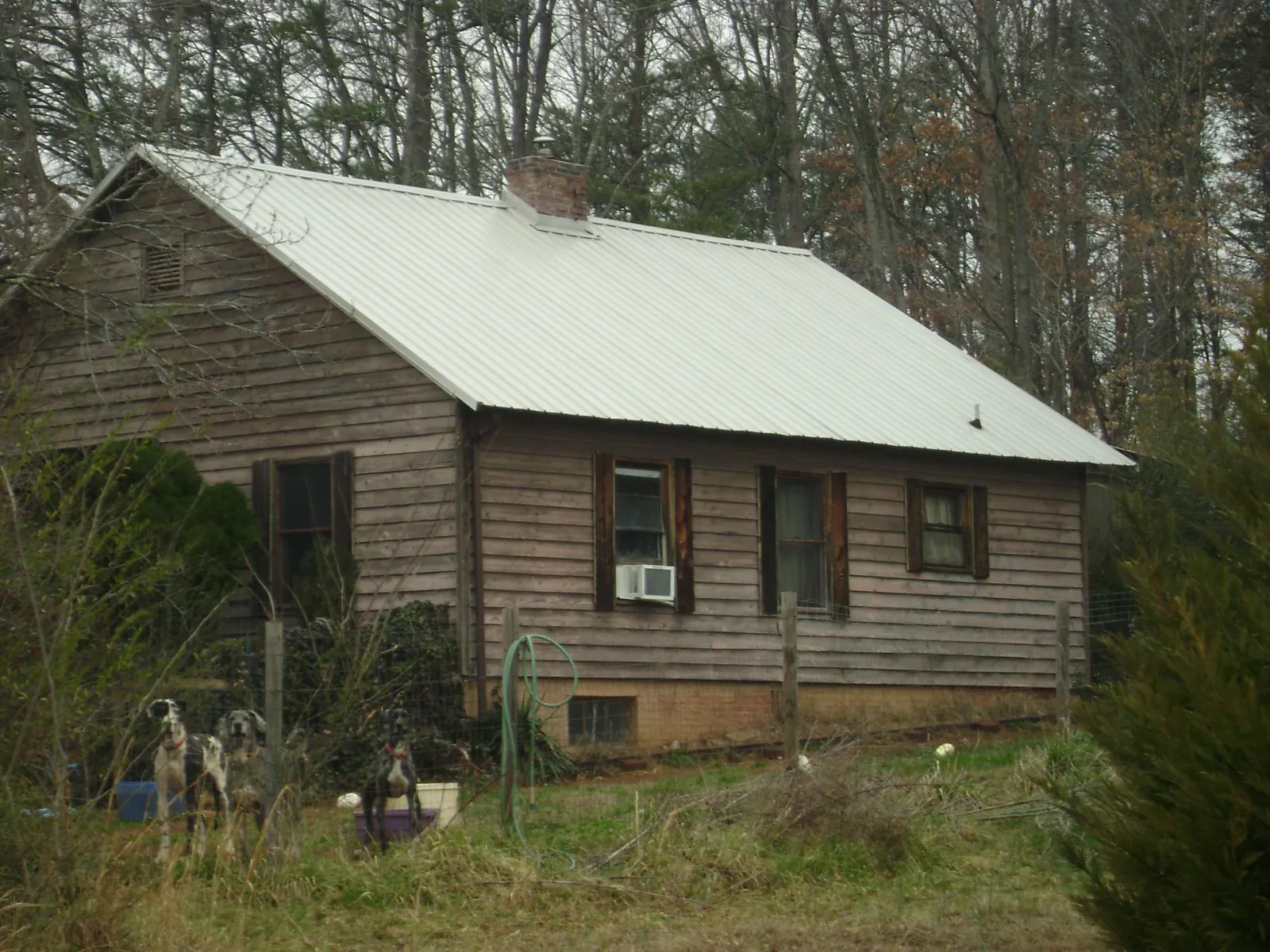 White metal roof on an old wood sided farmhouse, from a Asphalt Shingle Roof Repair job in Mc Allister